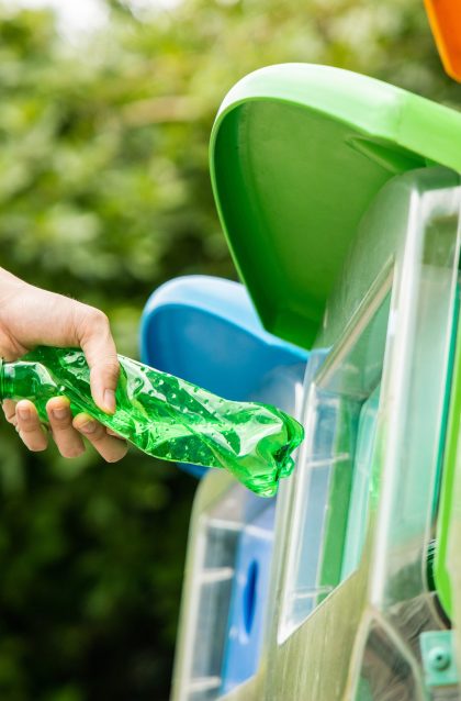 Close,Up,Shot,,Hand,Putting,Twisted,Green,Empty,Plastic,Bottle
